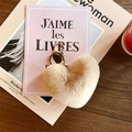 Close-up of a beige plush heart-shaped keychain with a gold metal ring on a pink background - Beige