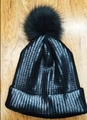 Black knit beanie with silver stripes and fluffy pompom on wooden surface - Adult / Black