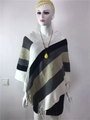 Detail of diagonal stripe knit poncho featuring fringe hem on a white mannequin - Tops / Grayish White / 60-80cm