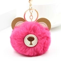 Close-up of fluffy pink faux fur bear keychain with gold clasp and leather ears - Rose Red