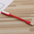 Flexible red silicone USB LED night light on a minimalist wooden desktop background - Red