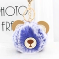 Detail of blue and white plush ball keychain with brown leather ears and gold metal clip - Royal Blue Frost