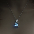 Glow-in-the-dark mermaid locket necklace with blue luminous bead on a dark mannequin - Sky Blue Luminous Mermaid (NY313)