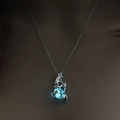 Close-up of a silver mermaid necklace with a glowing blue-green luminous bead charm - Blue-Green Luminous Mermaid (NY312)