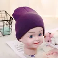 Dark purple knitted beanie hat for toddlers made of soft warm yarn on display - Adjustable / Violet