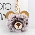 Close-up of cute brown spotted plush bear keychain with premium golden lobster clasp - Brown Frost