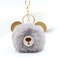 Detail of cute grey faux fur pompom keychain with brown leather bear ears and gold metal clasp - Light Gray