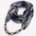 Detail of dark blue chiffon scarf with white tropical leaves and beaded jewelry pendant - Dark Blue and White