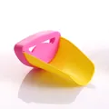Detailed view of pink and yellow crab-shaped faucet extender for kids' easy hand washing - Duck Mouth / Pink/Yellow