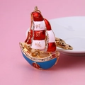 Golden sailboat keychain with red enamel and rhinestones featuring lucky Chinese symbols - Fu Character Sailboat