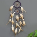 Purple double-ring dream catcher featuring brown feathers and black-and-white beads - Purple