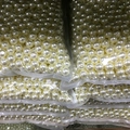 Detailed view of bulk ivory ABS faux pearls with pre-drilled holes for DIY jewelry - Premium No Hole / 1mm / Pearl