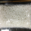 Macro view of loose white ABS imitation pearls in a wholesale bulk package - Premium No Hole / 1mm / Pure White
