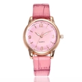 Minimalist women's quartz watch with rose gold case and pink leather strap on white background - Pink