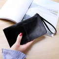 Classic black leather long wallet for women with zipper closure and wrist strap detail - Black