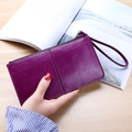 Purple long zipper wallet for women with wrist strap and multi-card slot design - Purple