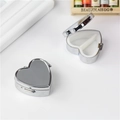 Silver heart-shaped metal pill box with a dual-compartment interior shown open and closed - Heart Shape 2-Grid Detachable