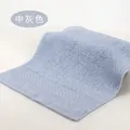 Soft medium grey cotton face towel with absorbent plush loops and woven border - 34x34cm / Medium Grey