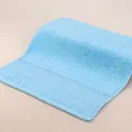 Light blue absorbent cotton face towel with geometric woven border and soft texture - 34x34cm / Forget-me-not