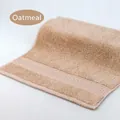 Soft cotton hand towel in White Oak color featuring a textured jacquard border trim - 34x34cm / White Oak