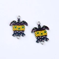Macro detail of colorful sea turtle metal charms with geometric pattern and double loops - Yellow