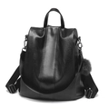 Women's vintage black soft PU leather backpack with decorative pompom charm and zipper - Black