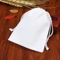 White cotton drawstring jewelry pouch on wooden board with decorative wheat accents - White; 5*7cm