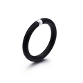 Minimalist matte black ring with a single white pearl accent on a clean white background - US 7 / Black