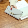 Long light gray leather wallet for women with V-shaped flap and gold metal buckle - Gray