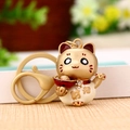 Golden Maneki Neko keychain with cream enamel finish and sparkling rhinestone bowknot - Matte Lucky Cat