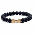 Black volcanic stone bead bracelet with a gold dumbbell charm on a clean white background - 17cm / Lava Stone + Gold Dumbbell