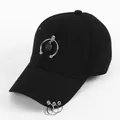 Detail of black cotton baseball cap featuring silver rings on brim and smiley pendant - Semicircle Smile Face