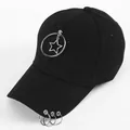 Detail of black cotton baseball cap with punk star pendants and metal ring accents - Ring with Pentagram
