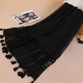 Elegant black long scarf with lace patchwork and tassel details on a minimalist background - Black