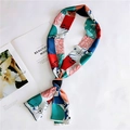 Detail of multi-color geometric silk scarf on fashion magazine with elegant drape - 2 Frames and Circles