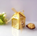 Golden laser-cut wedding favor box with heart patterns and a matching ribbon bow - Reflective Gold