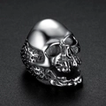 Detailed close-up of a silver punk skull ring with polished metallic finish and dark shadows - Steel Color (05405)