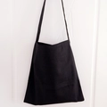 Detailed view of the thick black canvas tote bag with durable shoulder strap design - Black