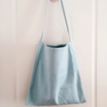 Light blue canvas tote bag with dark green lining and minimalist shoulder strap design - Light Blue