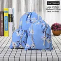 Three-piece set of blue linen drawstring storage bags with white floral daffodil prints - Narcissus