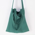 Detail of dark green canvas tote bag showing thick fabric texture and shoulder strap - Dark Green