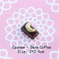 Macro detail of a 2x3.4cm cashew chocolate resin accessory for DIY keychain making - Cashew - Dark Coffee