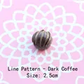 Detailed view of a 2.5cm dark coffee resin button with decorative golden spiral lines - Line Pattern - Dark Coffee