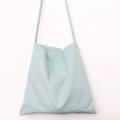 Close-up of mint green canvas tote bag fabric texture and shoulder strap details - Haze Blue