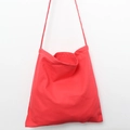 Detail of red canvas tote bag showing white stitching craftsmanship and slim shoulder straps - Watermelon red
