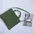 Olive green canvas tote bag with dual handles and shoulder strap on white background - Army Green