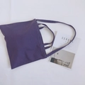 Detail view of purple canvas tote bag with dual handles on white background - Purple