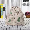 Three cotton linen drawstring bags with green pine leaf prints in various sizes - Pine Needle
