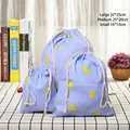 Three-piece set of blue linen drawstring storage bags with yellow banana print - Banana