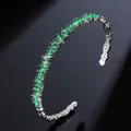 Silver cuff bangle featuring emerald green rectangular zircons in a single row setting - Green Zirconia White Gold Plated